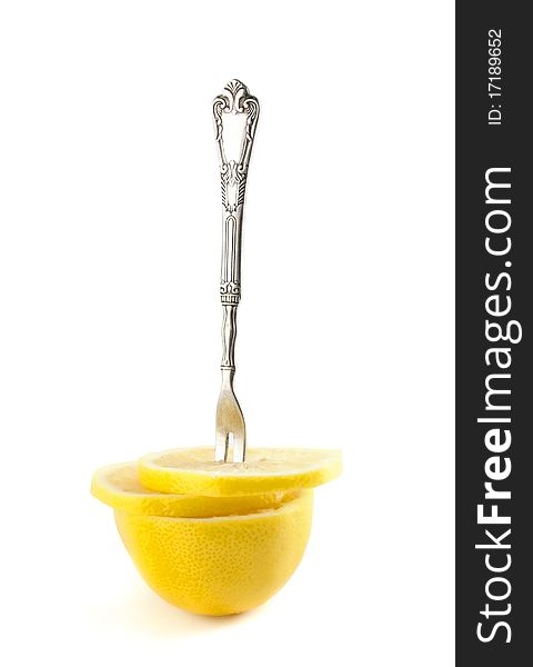 Llemon slices with a fork. Isolated on a white background