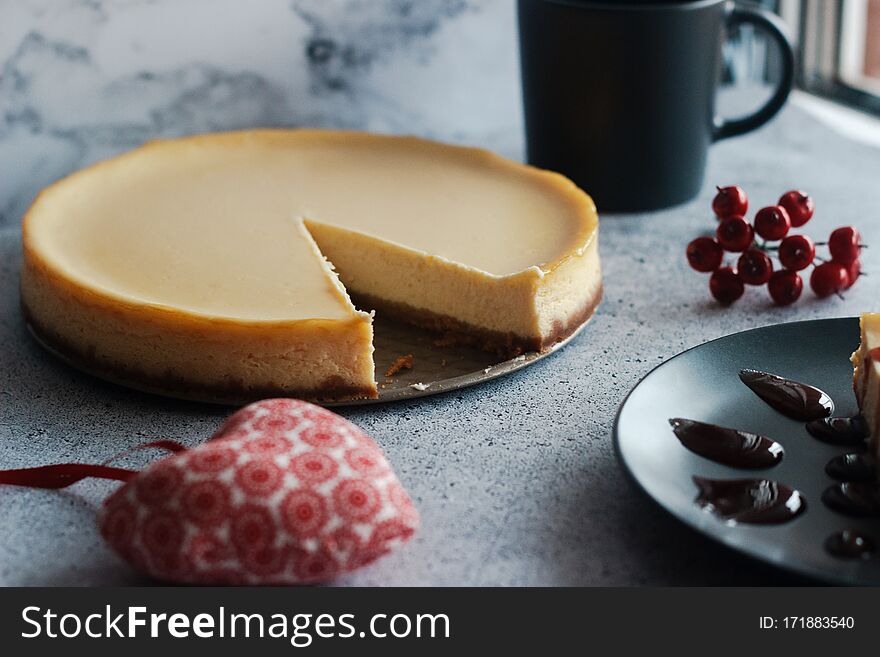 Cheesecake on a plate with strawberry sauce