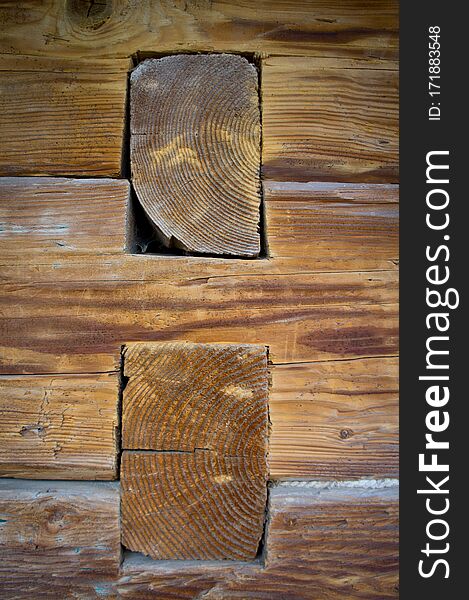 The texture of the logs of an old wooden house. Background for environmentally friendly construction from natural materials. Old