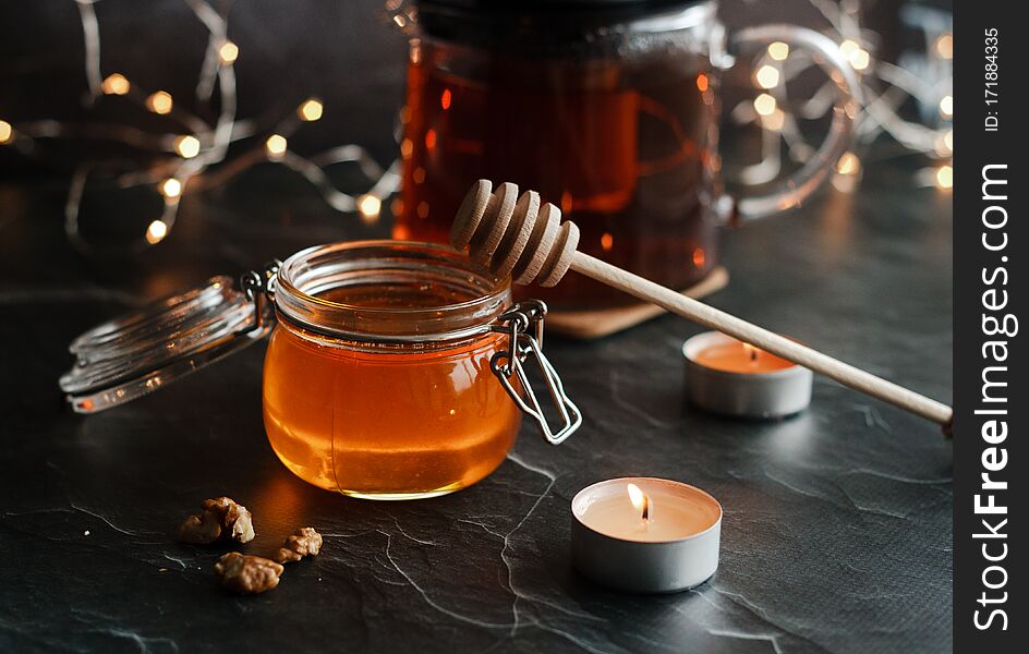 Jar of honey with candles and other romantic elements