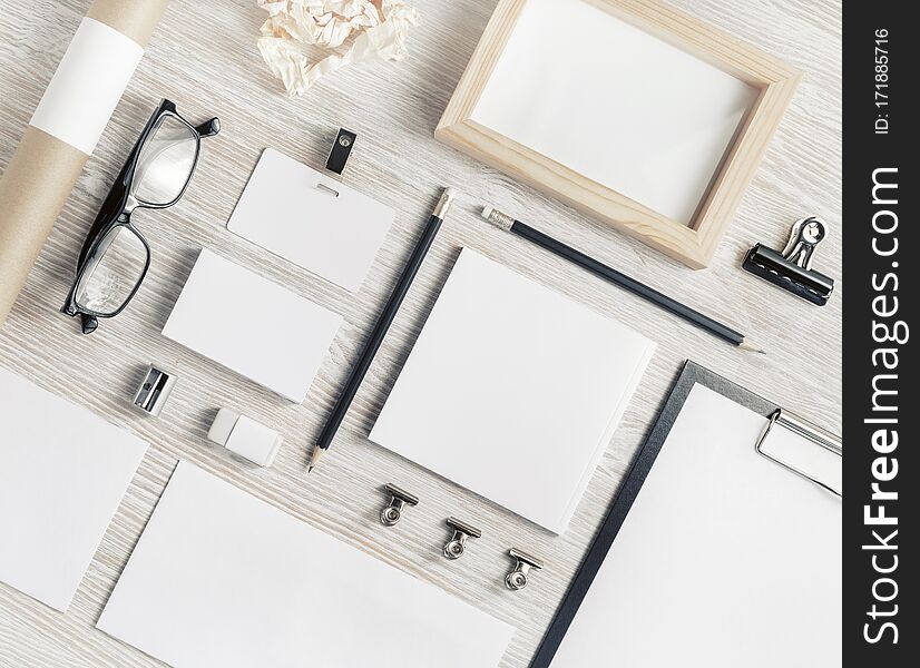 Blank corporate stationery set on light wood table background. Branding mock up. Flat lay