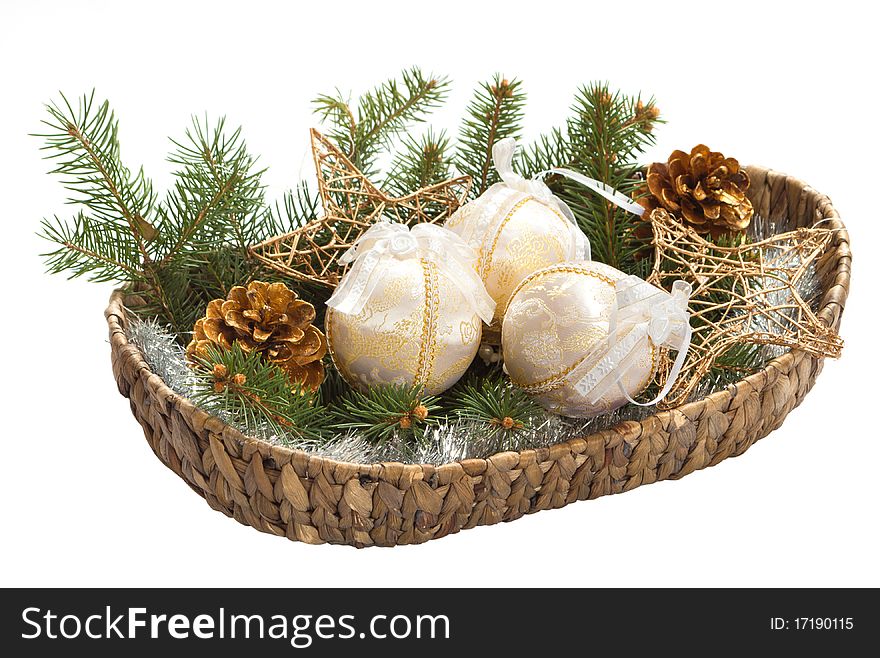 Basket with christmas bulb, fir branch and cone isolated on white