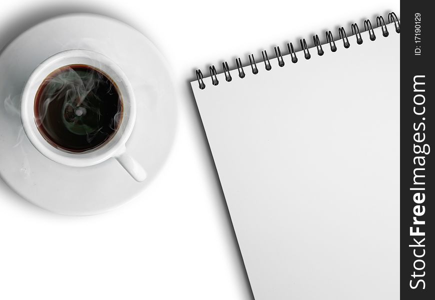 White cup of hot coffee and notebook on white background