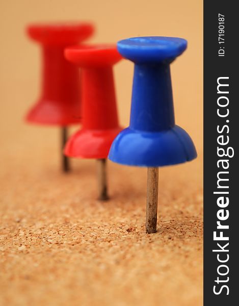 Pushpins on a corkcoard. Macro closeup with shallow depth of field. Pushpins on a corkcoard. Macro closeup with shallow depth of field.