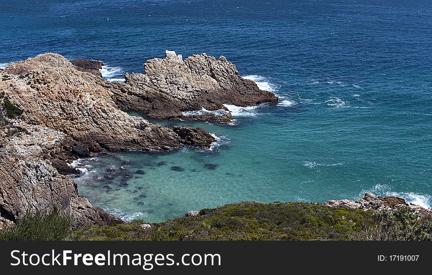 A panoramic view of an outcrop of rock and the ocean between Cape Town and Cape Hangklip on the Atlantic Ocean seaboard, South Africa. A panoramic view of an outcrop of rock and the ocean between Cape Town and Cape Hangklip on the Atlantic Ocean seaboard, South Africa