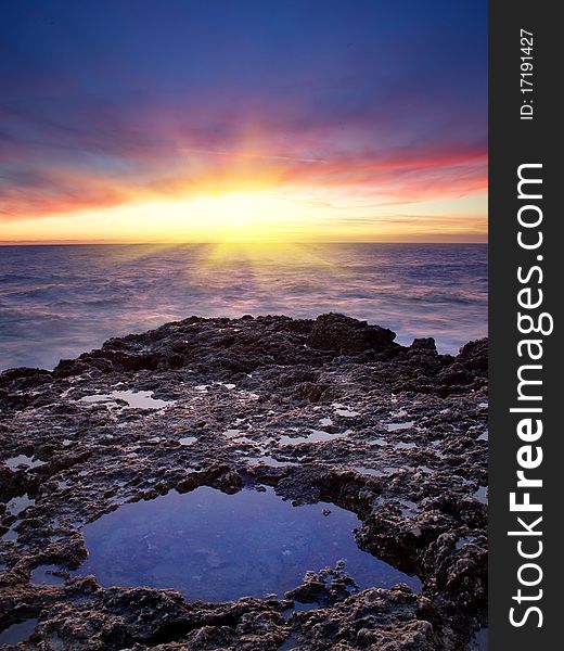 Sea and reflection in water during sundown