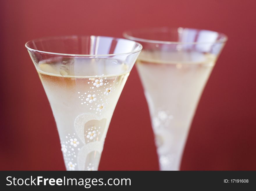 Two champagne glaases on red background