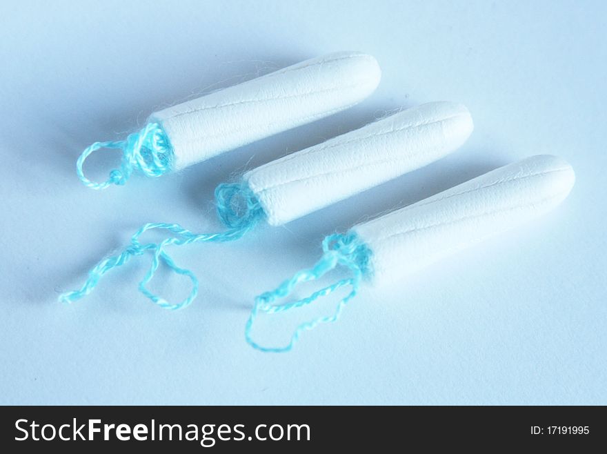 Health care and medicine - white tampons on blue background