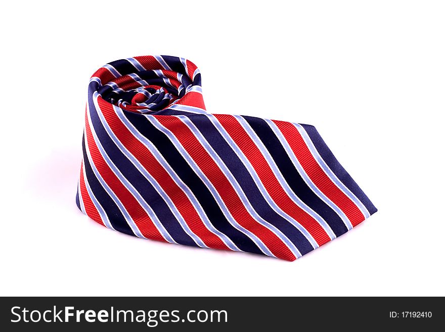 Striped Red and Blue Neck Tie rolled up into a coil. Striped Red and Blue Neck Tie rolled up into a coil.