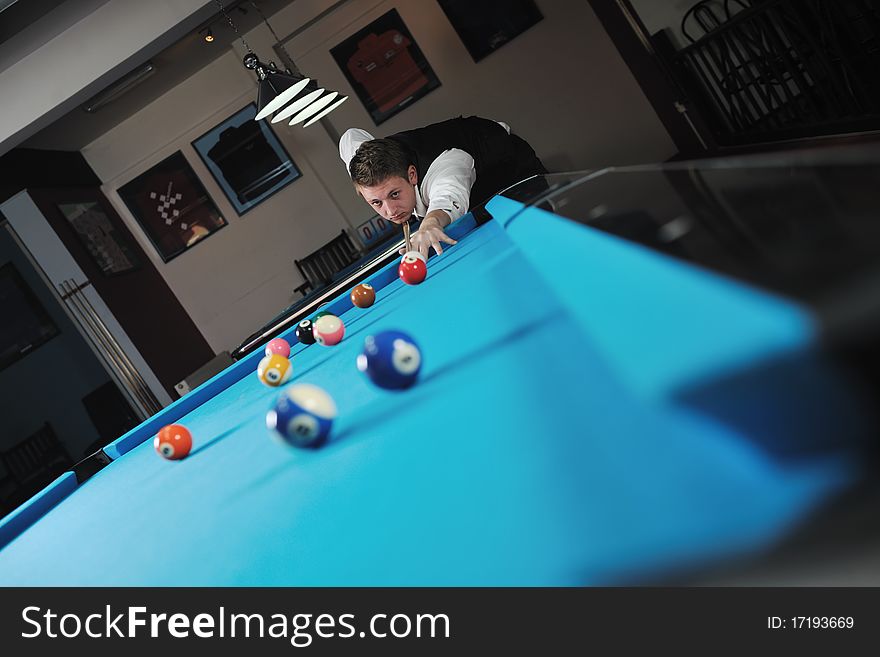 Young man play pro billiard game