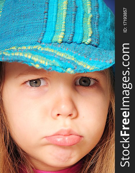 Angry girl with blue hat