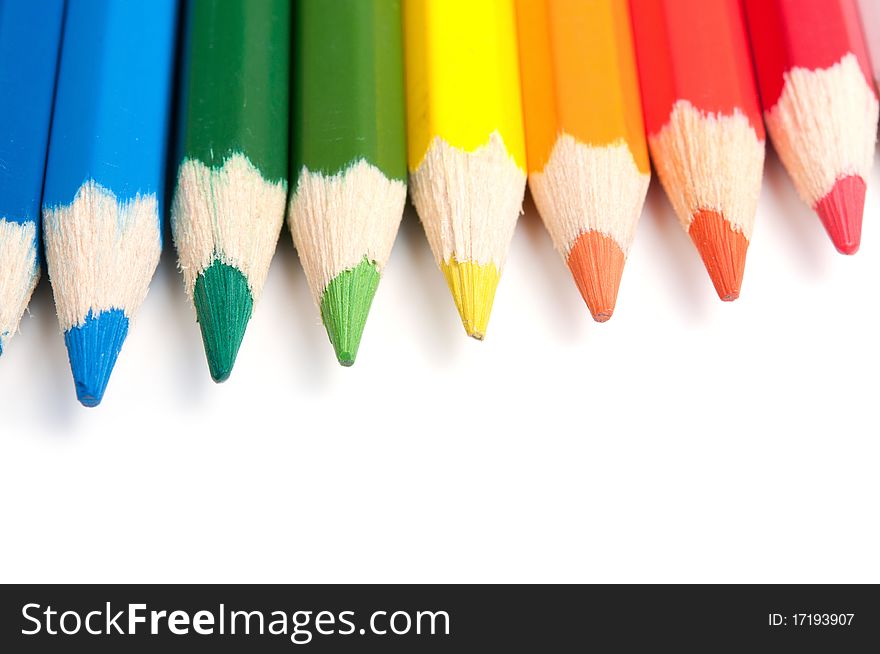 Colored pencils isolated on white background, close-up, selective focus. Colored pencils isolated on white background, close-up, selective focus.