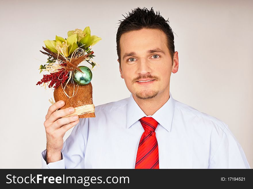 Young man in shirt and tie hold in hand a Christmas gift. Young man in shirt and tie hold in hand a Christmas gift