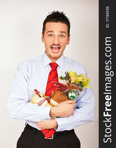 Young man in shirt and tie hold in hand a Christmas gift. Young man in shirt and tie hold in hand a Christmas gift