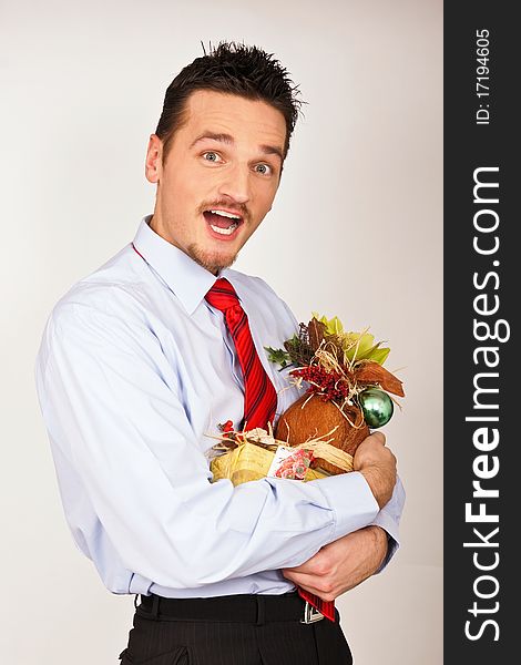 Young man in shirt and red tie hold Christmas gift and he is surprised. Young man in shirt and red tie hold Christmas gift and he is surprised