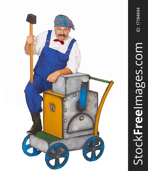 Cheerful worker in overalls with a hammer isolated. Cheerful worker in overalls with a hammer isolated