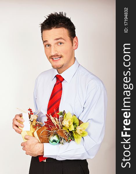 Young man in shirt and red tie hold Christmas gift and he is surprised. Young man in shirt and red tie hold Christmas gift and he is surprised