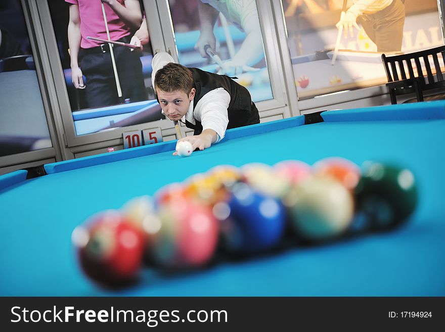 Young pro billiard player finding best solution and right angle at billard or snooker pool sport  game. Young pro billiard player finding best solution and right angle at billard or snooker pool sport  game