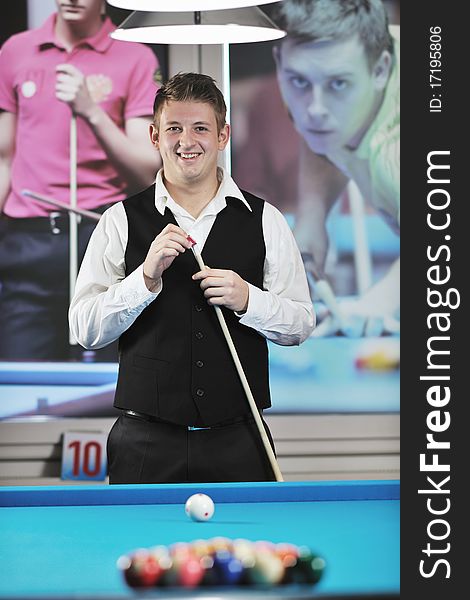 Young pro billiard player finding best solution and right angle at billard or snooker pool sport game. Young pro billiard player finding best solution and right angle at billard or snooker pool sport game