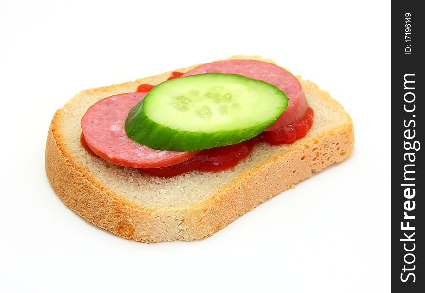 Healthy sandwich with Ketchup sausage and a cucumber on a white background