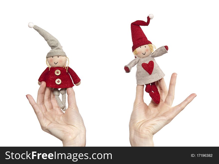 Studio photo of woman's hands playing with puppets. Pair of dwarves on the white background.