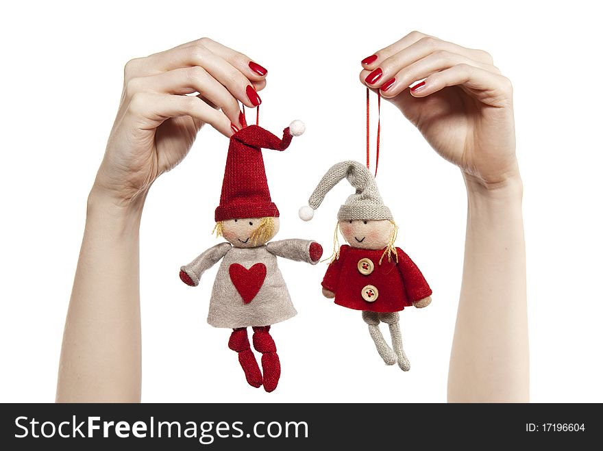 Studio photo of woman's hands playing with puppets. Pair of dwarves on the white background.