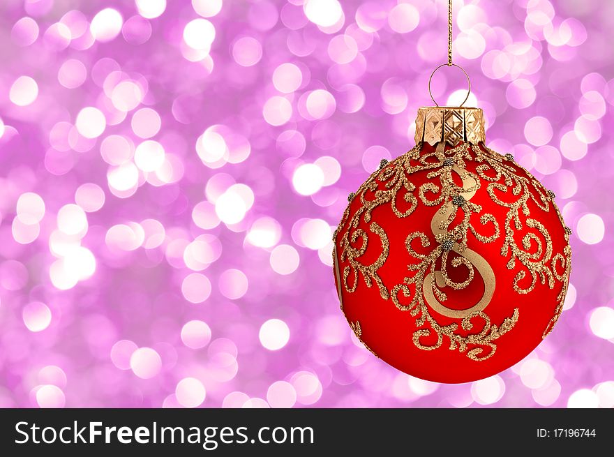 Christmas ball on abstract violet lights as background