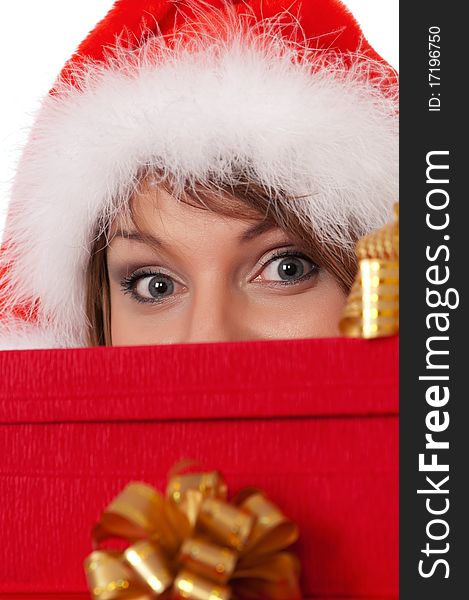 Christmas girl holding gifts wearing Santa hat. Close-up.