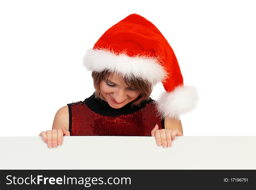 Beautiful christmas girl wearing Santa hat, holding a white blank. Isolated on white background.