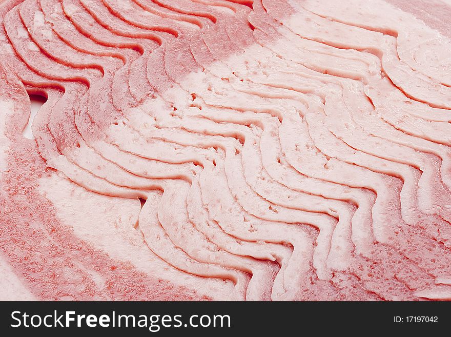 Raw bacon, cut thin slices, without packaging.