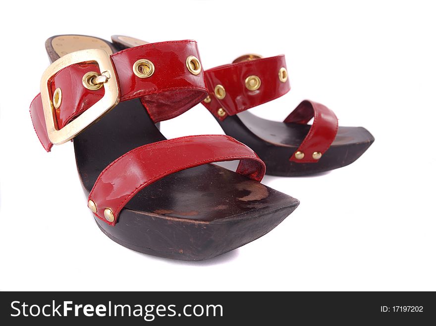 Red female shoes with a buckle on a white background