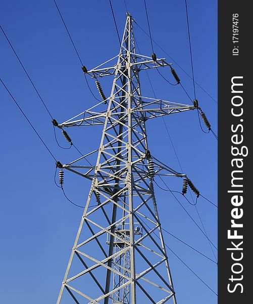 High voltage electric post and power lines on the blue sky