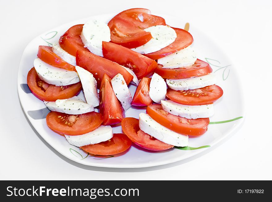 Tomatoes with mozarella on a plate, with spices