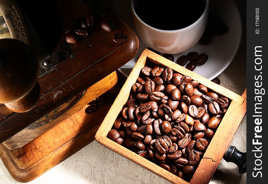 Cup of espresso coffee, coffee beans and old grinder. Cup of espresso coffee, coffee beans and old grinder