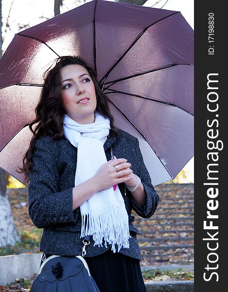 Beautiful girl with an umbrella on the steps of an abandoned ladder. Beautiful girl with an umbrella on the steps of an abandoned ladder.