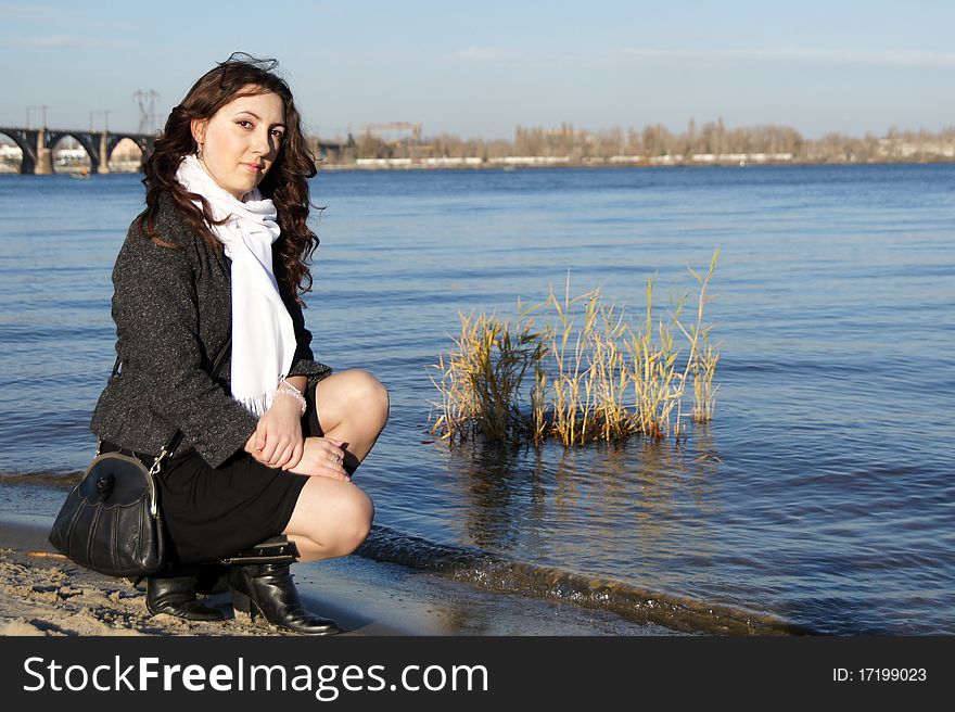 The girl knelt down at the water's edge. The girl knelt down at the water's edge.