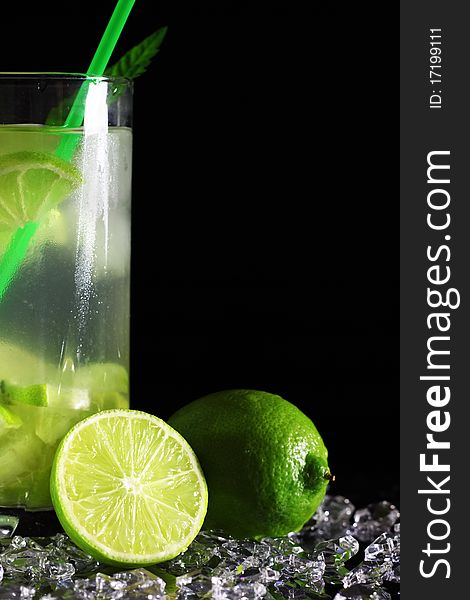 Mojito cocktail with fresh limes on a black background