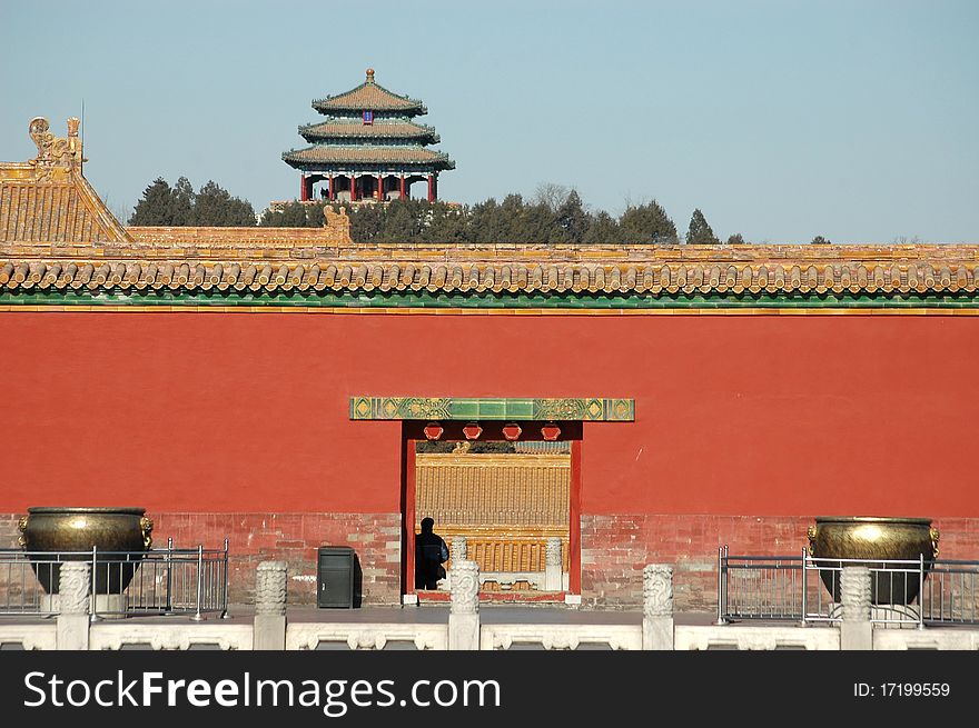 A scene of Jingshan park in Beijing, China. You can see the summerhouse behind the red wall.