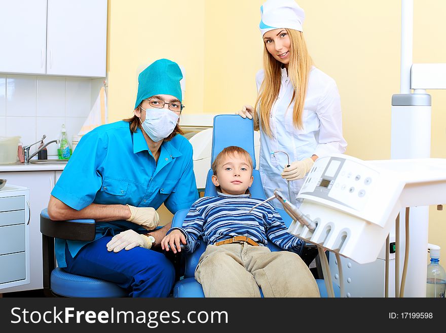 Shot of a little boy with dentists in a dental surgery. Healthcare, medicine.