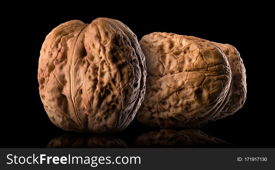 Set of whole walnuts isolated on a black background.