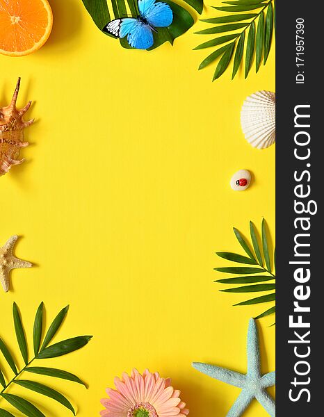 Summer Tropical Background. Palm Trees Branches, butterfly, starfish and seashell on yellow background. Summer concept.Travel. Copy space.