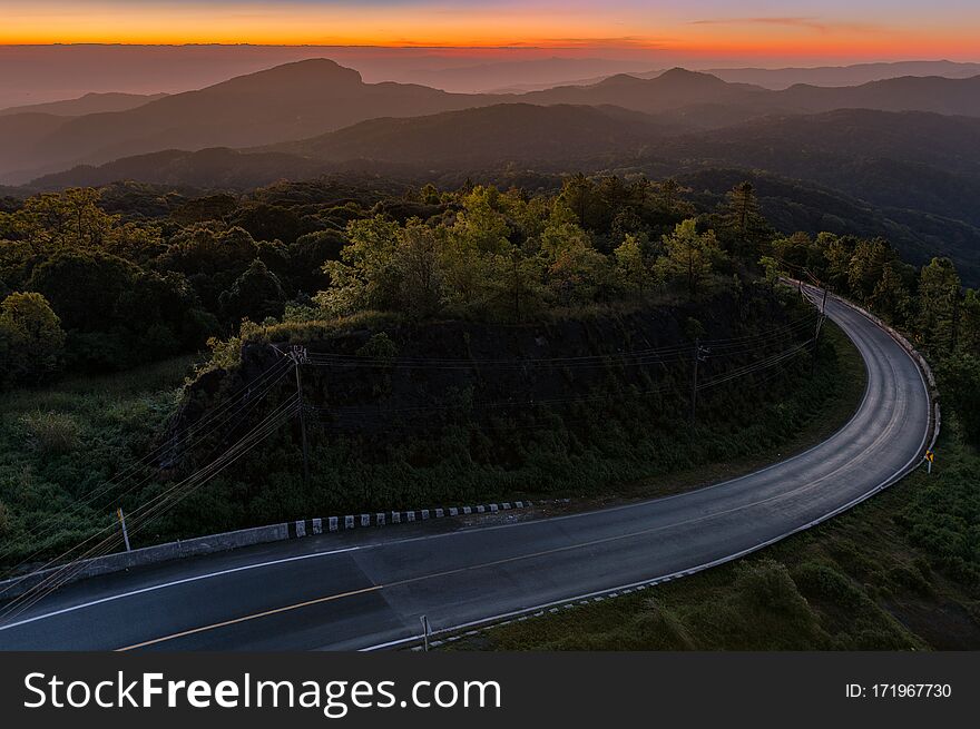 Beautiful sunset sky and clouds over mountain with Fog and main road. The Doi Inthanon National Park in Chiang Mai, Thailand. Beautiful sunset sky and clouds over mountain with Fog and main road. The Doi Inthanon National Park in Chiang Mai, Thailand