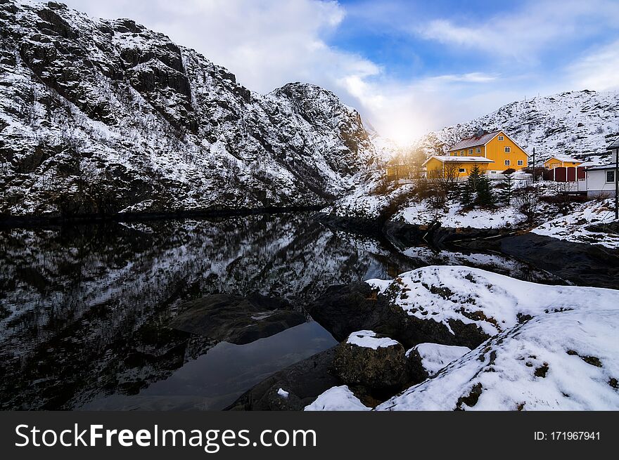 Yellow fisherman houses iconic Reine Village, Lofoten Islands, Norway