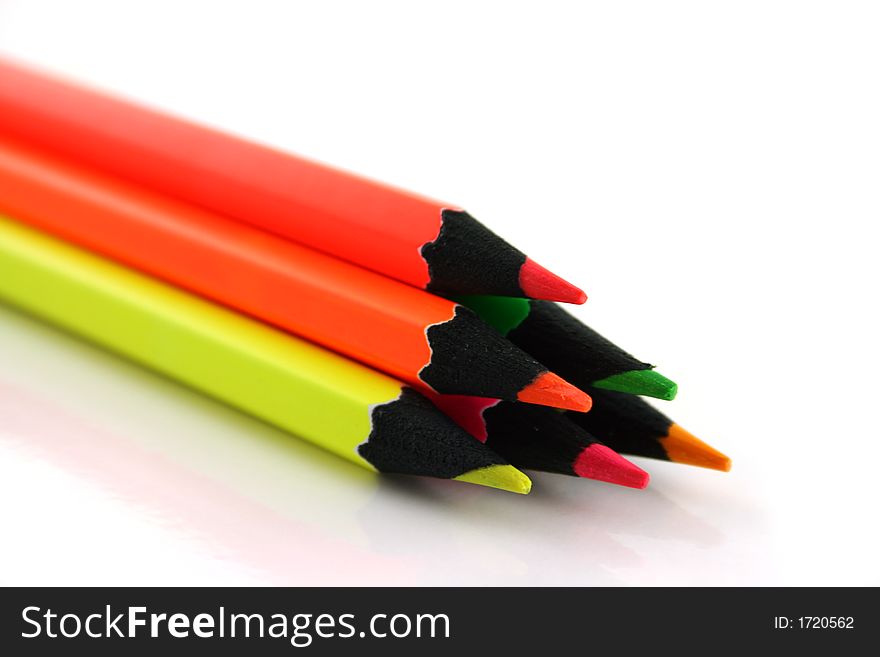 Pyramid of 6 neon pencils on a white background