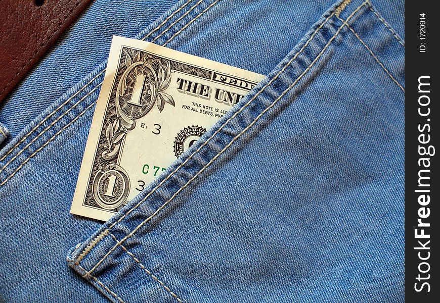 One dollar bill within back pocket of jeans