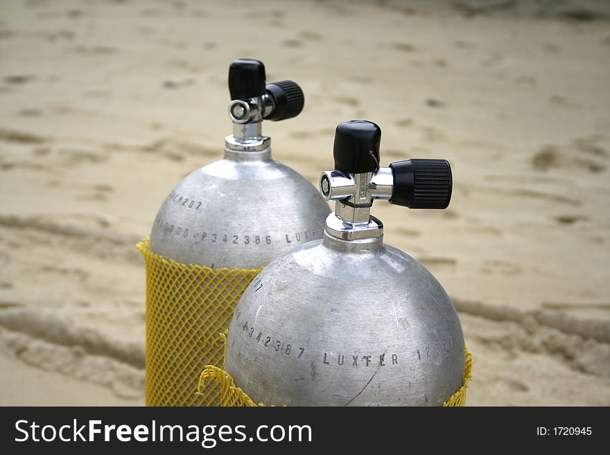 Diving scuba tanks left at the beach. Diving scuba tanks left at the beach.