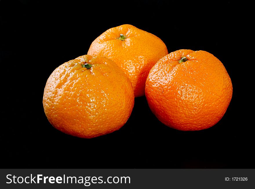 Tangerines isolated on black background
