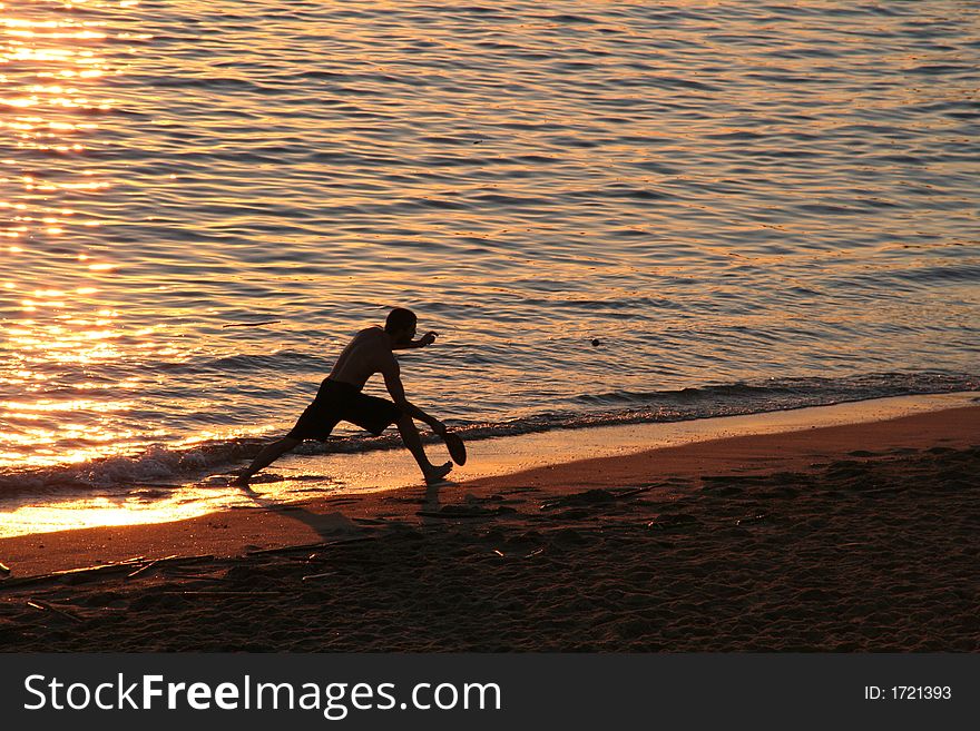 Playing Racket Ball at a beach Sunset. Playing Racket Ball at a beach Sunset