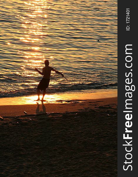 Playing Racket Ball at a beach Sunset. Playing Racket Ball at a beach Sunset