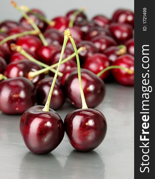 Some cherries on a grey background. Some cherries on a grey background